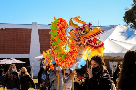 (Above, from left to right) Kate Ward, grade 9, Grace Wright, grade 9, Tynan Tracy, grade 9, Wali Hasan, grade 9, and Sophia Carraway, grade 10, perform and enjoy the Chinese dragon dance. The dragon dance was performed by LHP’s Chinese I and II classes in front of the Calkins Library, requiring students to build teamwork in order to learn how to walk together gracefully. The dragon dance is both a showcase of unification and power. 