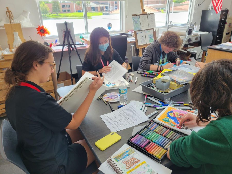 (Above) AP Art students work on their individual projects
during classtime. Their pieces count towards their end of
the year AP portfolio. Students use an array of mediums
such as markers, pastels, and pens to create their pieces.
Photo by Serena Young.