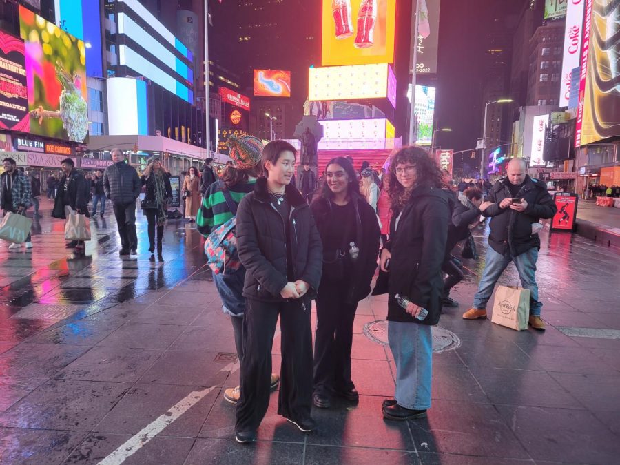(Above) Left to right, Ziqin Chiodi, grade 11, Merium Qureshi, grade 11, and Elisa Davis, grade 11, take in Times Square after a dinner of New York City pizza. The skyscrapers hundreds of feet tall are each branded by flashing colors and messages making standing in front of The Ball feel like standing inside a computer. The girls have some free time before the large group reconvines to head back to the Hilton hotel to sleep. All photos by Serena Young.  

