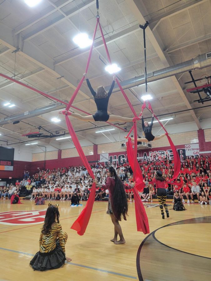 (Above) At the Homecoming pep rally, David Copperfield’s Project Magic
astounded the audience in their circus themed costumes as a tribute to the
shows in Las Vegas. Shown are Tina Zhang, grade 12; Aishwarya Vangala,
grade 11; Ava Sharon, grade 11; Karisma Kohn, grade 11, and Carolyn Rogers,
grade 11, on tissu—more commonly known in the dance world as aerial silks—
in a performance directed by Ms. Ginger Bryant. Incredibly, before taking
the class, more than half the cast had never touched a magic trick before,
and yet their performance was ready after 26 days of 45-minute practices.

All photos by Serena Young.