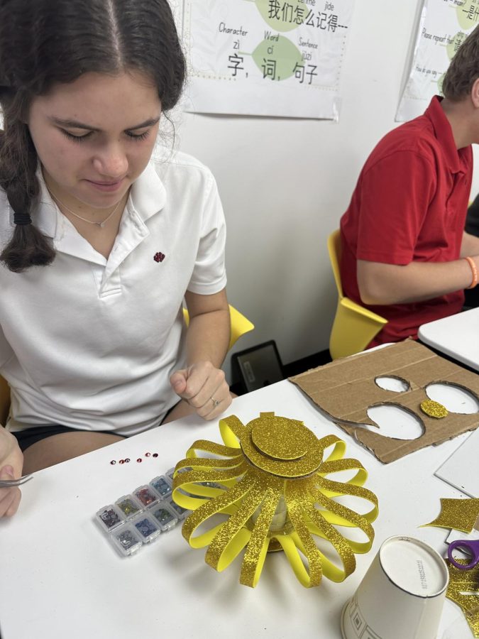 (Above) Alexandra Leary, grade 11, “[Hopes] that by creating these
lanterns out of recycled materials, [she] can inspire others to think
more about their impact on the environment and to recycle more.”
The students also add fun decorations, like jewels, to their lanterns to
brighten the days of those who pass by. Photo courtesy of

William Beamer.