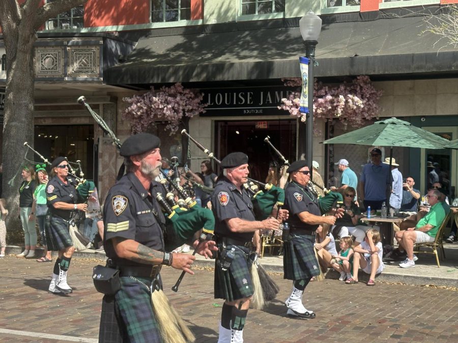 (Above) The traditional bagpipe, a huge symbol of Irish culture, has been played for every single Win-
ter Park St. Patrick’s Day Parade. Bagpipes are woodwind instruments with reed pipes that are sound-
ed by the pressure of wind emitted from a bag squeezed by the player’s arm. The players typically

wear kilts, belt buckles, and other accessories of the traditional Irish bagpiper. There’s no St. Patrick’s

Day without hearing the tunes of an Irish bagpipe! Photo by Alyssa Wiboon.