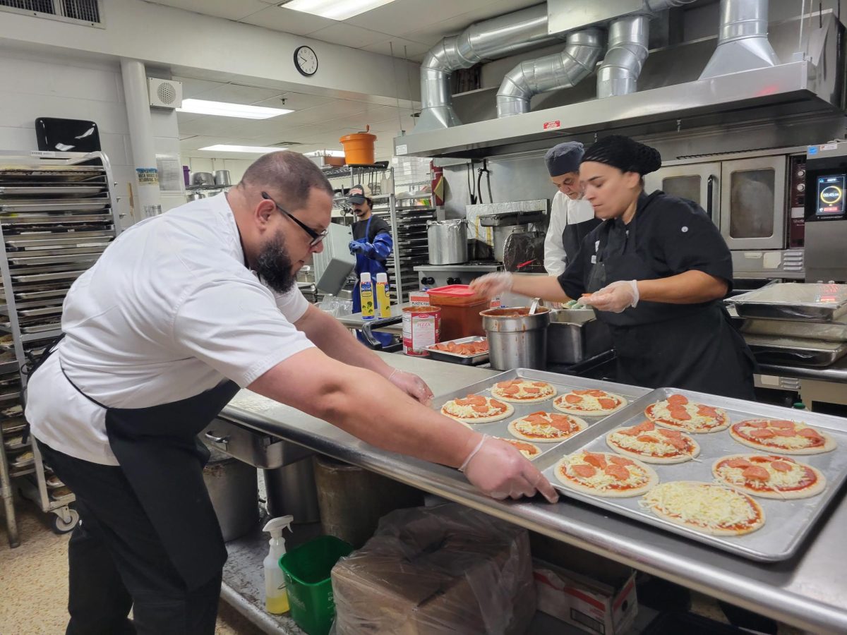 (Above) Chef Jose Tavarez and Ms. Carmen Ortiz work together to make delicious pepperoni pizzas for Friday’s lunch. At FLIK, all the meals rotate in five-week cycles, and each day of the week has a theme: Monday is comfort food, Tuesday is Latin American food, Wednesday is Italian food, Thursday is Asian food, and Friday is pizza. 