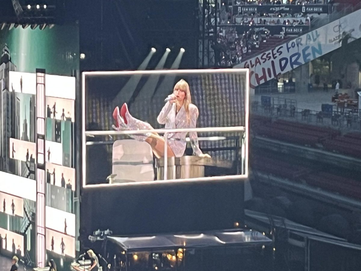 (Above) One of the biggest themes featured in Taylor Swift’s songs is the patriarchy.
Seen through lyrics like, “He wanted a bride; I was making my own name” from the
song “Midnight Rain” and most notably, “Wondering if I’d get there quicker If I was a
man” from the song “The Man” pictured here. The Eras’ Tour is a testament to how much
Swift has broken barriers as a woman. At Raymond James Stadium alone, Swift became
the first act in history to sell out two shows on a single tour, let alone three. Even
before the tour, Swift was the first female solo artist to win Album of the Year twice
(later on she would win a third with Folklore). In the Eras’ Tour, during the song, “The
Man” Swift literally climbs up the corporate ladder, finishing the song by manspreading

on the top desk.