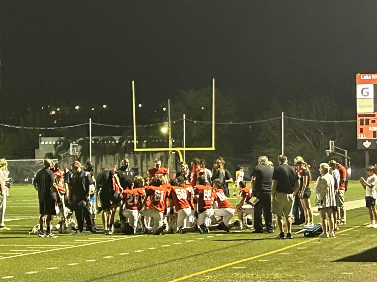 (Above)  The football team reflects on the game against Orangewood Christian Academy. The post-game speech consists of the highs and lows of the game. It is important to remember on the game to help them know what they will work on in practice, and what to look for when watching a game or practice film next. Coach Bullock tells the xteam what he saw in the game, making sure to spotlight the plays of the game and impact players. Also during the speech, Coach Bullock makes sure to mentally prepare the team for the next game. Coach Bullock always ends every speech on a high note., to keep his players’ energy up.