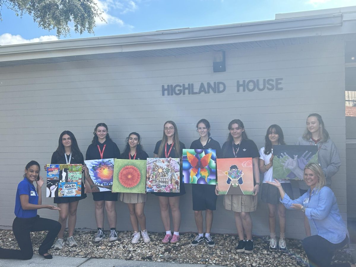 (Above) Before United Against Poverty takes Art Club’s paintings to their building, members pose with their final artworks. Members would spend hours working on these paintings to encourage donors to sponsor their future works.