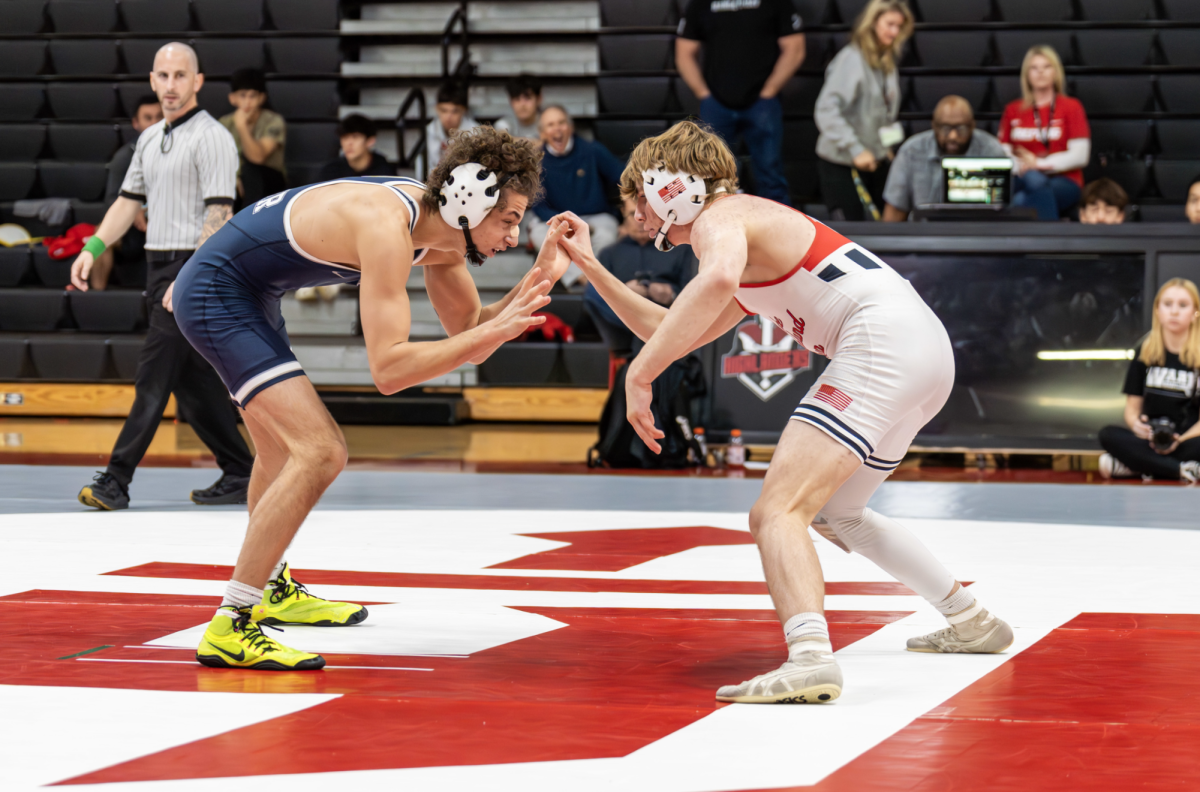 (Above) Clint Potner, grade 11, is getting ready to begin his wrestling match. Keeping his head in the game at all times is very important in such a quick- paced individual sport. Wrestler Ronin Gault, grade 11, mentions that, “Most of the team does their work after morning practice” which is an efficient way he makes sure he never falls behind in schoolwork. Their team tends to help each other and keep each other accountable with work. 