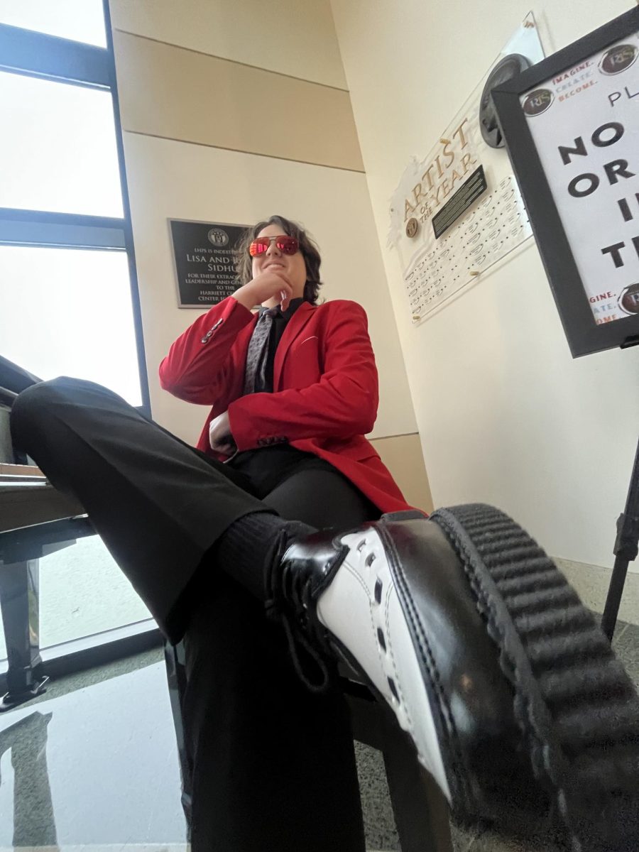 (Above) Zane Rimes, grade 12, drew inspiration for his look from his favorite artist, The Weeknd. The bright red suit and white and black shoes are sure to make a statement on the dance floor.
