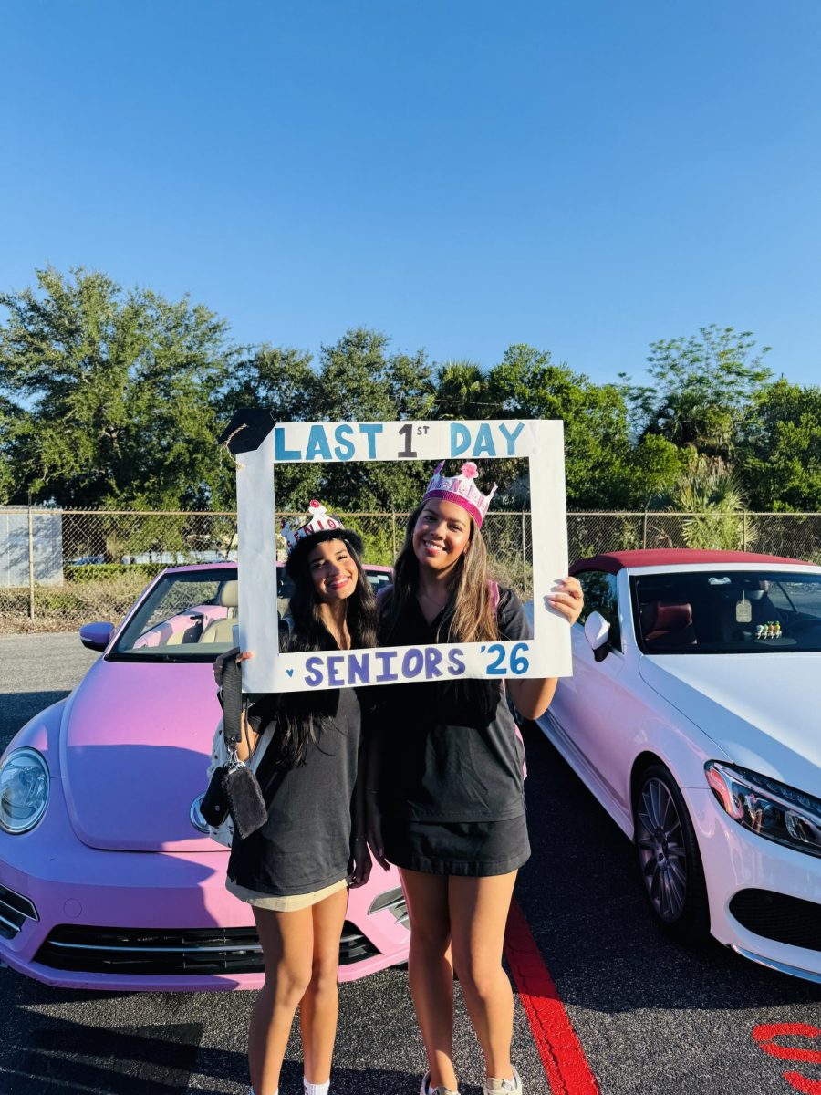(Above) From the student parking lot, Seniors are seen reminiscing on their  last year at Lake Highland. Decades later they will have fond memories of wearing their Senior crowns, which are perfectly captured in this moment.