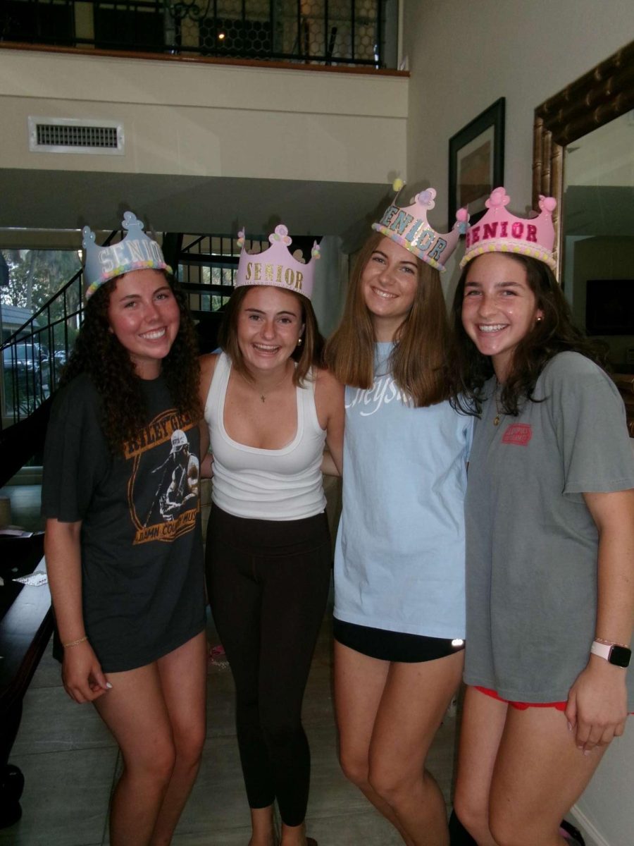 (Above) Seniors have fun hanging out before school starts to make their Senior crowns. They enjoy talking to one another and crafting their crowns with all types of materials.