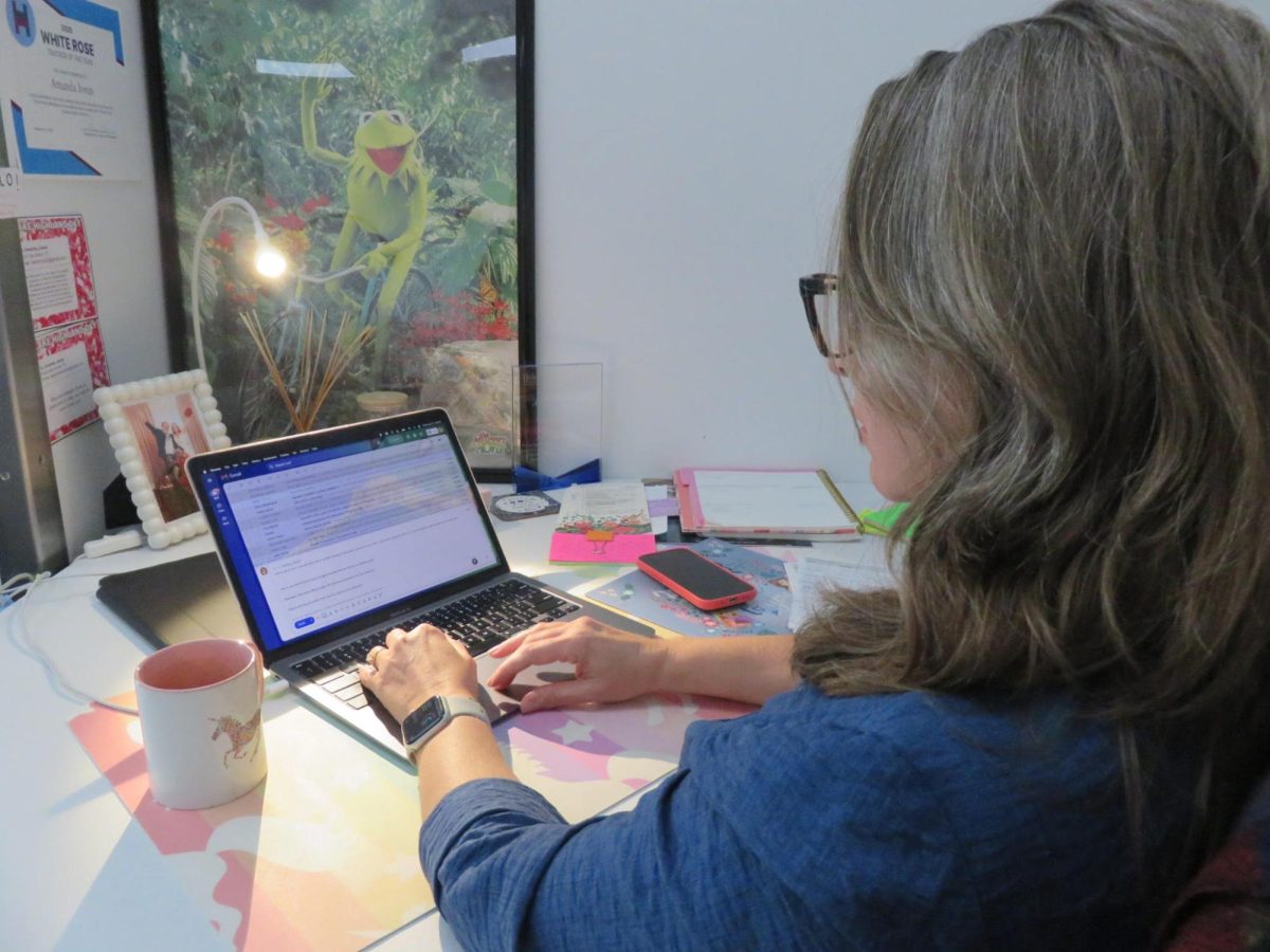(Above) From her classroom desk, Amanda Jones encourages students to rely on their own voices instead of A.I. While A.I. can generate polished work, she continues to remind them that their own voices, ideas, and creativity are what truly matters. 