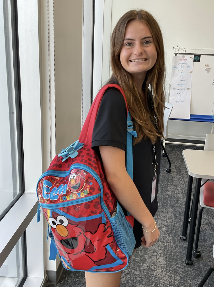 (Above) Molly Connolly, grade 12, shows off her Senior backpack saying “We all did cartoons for our last year of high school. I think it is so fun how everyone does funny backpacks for their Senior year.” Molly shows off her personality with her Elmo themed backpack.
