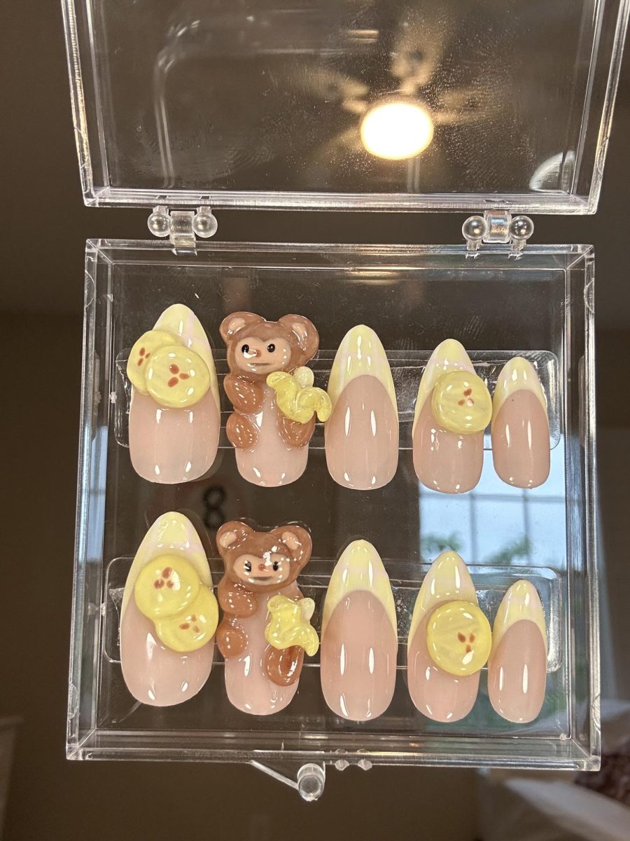 (Above) Mabel Lin uses 3D sculpting gel to craft intricate designs on her press-on nails. She uses precision to sculpt the monkey and banana figures followed by a glossy top coat to finalize the product. This ensures that they're ready to be shipped for a price of $35. Contact linma@lhprep.org for more information.