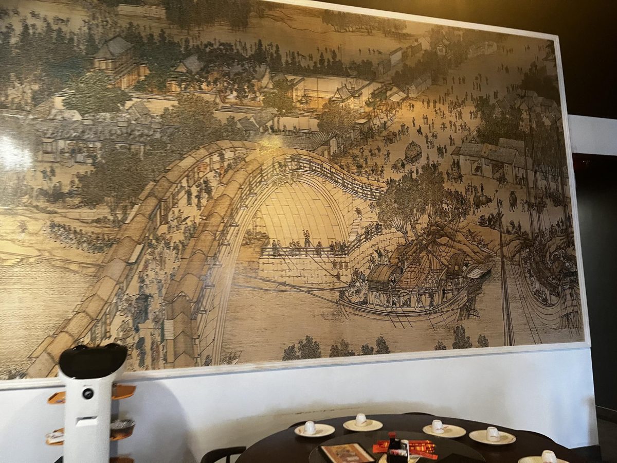 (Above) In the back of the restaurant there is a giant piece called Along the River During the Qingming Festival painted by Zhang Zeduan. This painting is meant to show the daily life of people from the Song period in Beijing. The piece was drawn on a handscroll, and was meant to show the different social and economic standings in China.