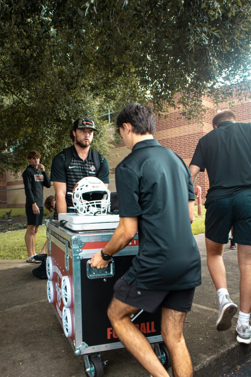 (Above) Transferring equipment to the field isn’t an easy process. Sometimes, schools have faculty members helping the visiting team transport all their equipment to the field.