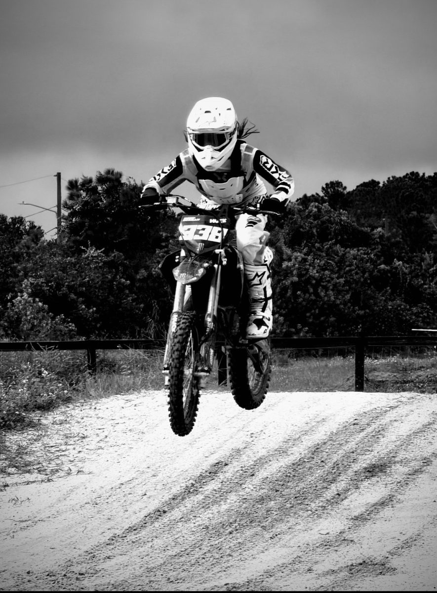 (Above) Layla McCord, grade 9, lifts off the track, capturing a moment of growth. She is determined and ready to display anything she learns on the track.