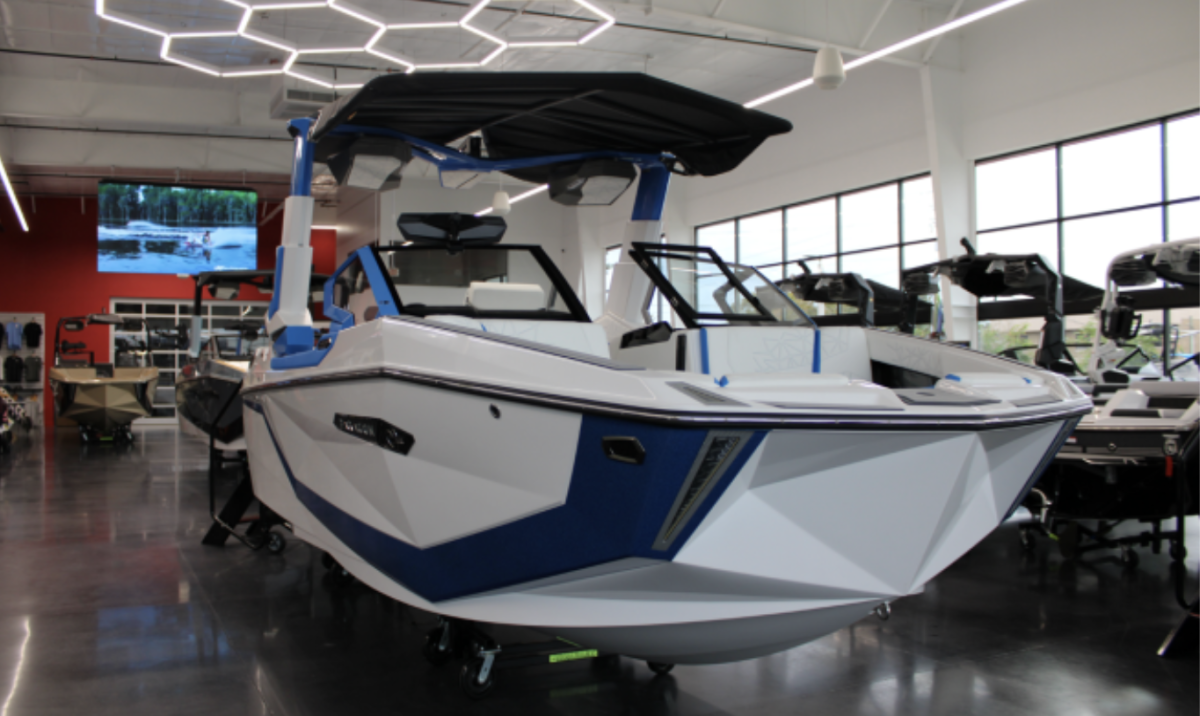(Above) This striking blue Nautique boat showcases the company’s dedication to
craftsmanship and innovation. Its unique design and vibrant color capture the spirit of life on the water. The layout is designed to make driving the boat feel smooth and effortless Every detail, from the smooth lines to the advanced features, reflects careful engineering
and attention to quality. The boat stands as a symbol of luxury and performance in the world of water sports.